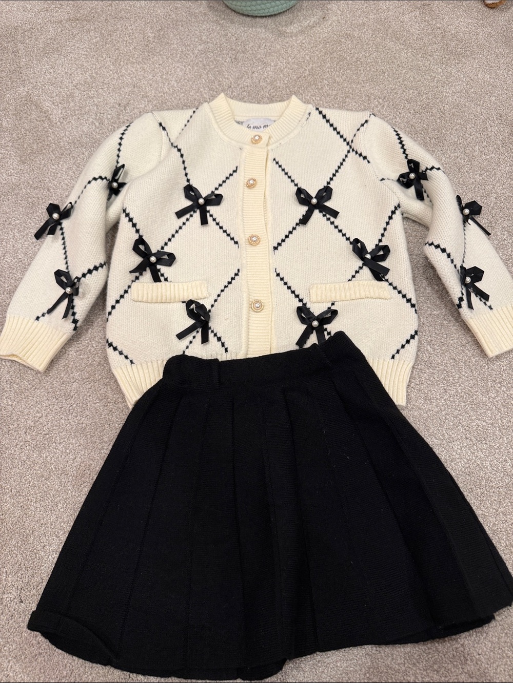 Cream Knit Bow Cardigan with Black Pleated Skirt